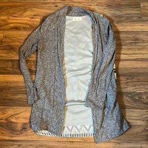 Grey Caedigan with decorative back.